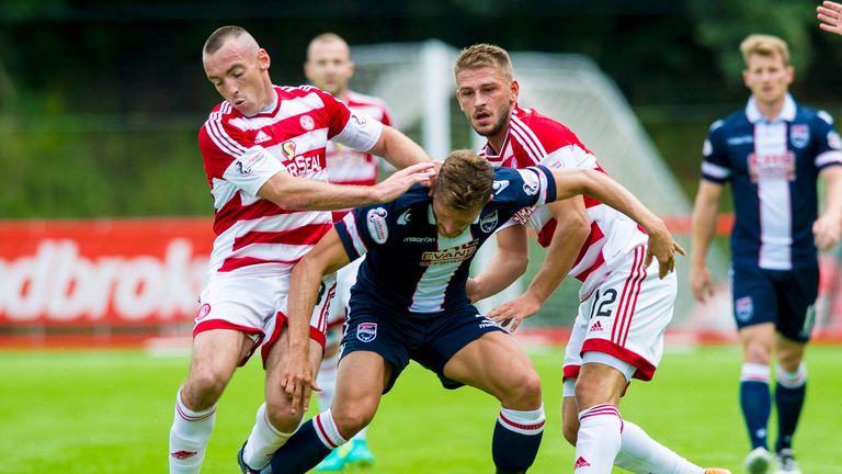 Hamilton's Darian Mackinnon (left) and Gramoz Kurtaj battle with Erik Cikos