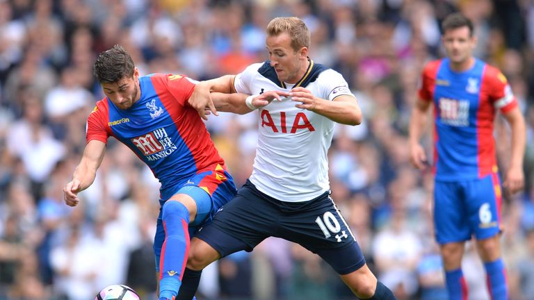 Harry Kane (R) battles for possession with Joel Ward