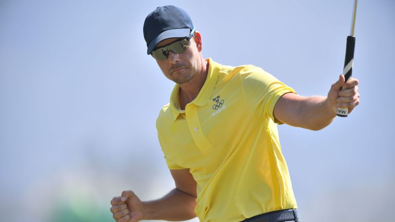 Sweden's Henrik Stenson celebrates a birdie that gets him tied for the lead with Rose of Britain in the men's individual stroke play final day at the Olymp
