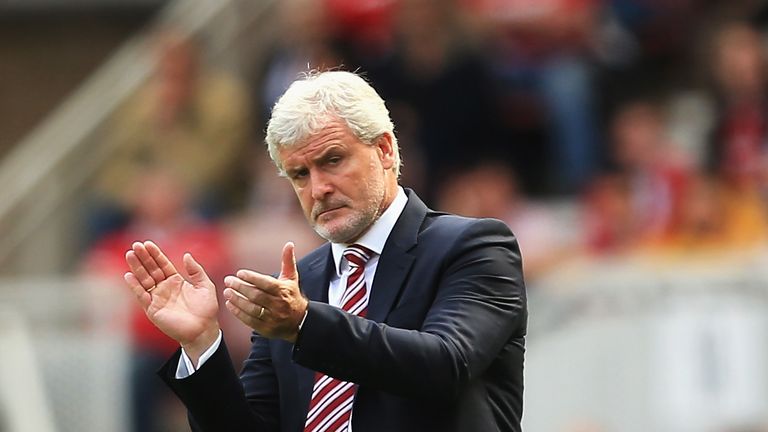 MIDDLESBROUGH, ENGLAND - AUGUST 13:  Mark Hughes, Manager of Stoke City give his team encouragement on the sidelines during the Premier League match betwee