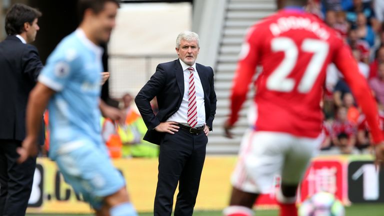  Stoke City's Welsh manager Mark Hughes (C) watches from the touchline during the English Premier League football match between Middlesbrough and Stoke Cit