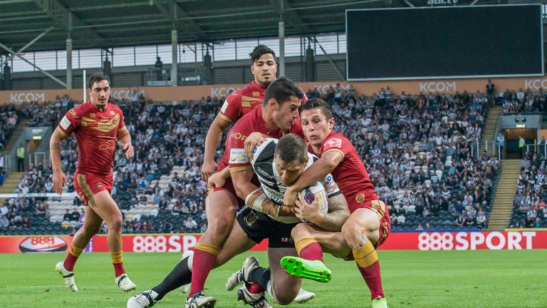 Hull FC 's Kirk Yeaman is tackled by Catalans' Jason Baitieri & Morgan Escare.