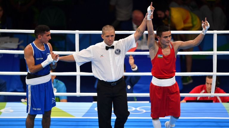 Uzbekistan's Hurshid Tojibaev (R) is through