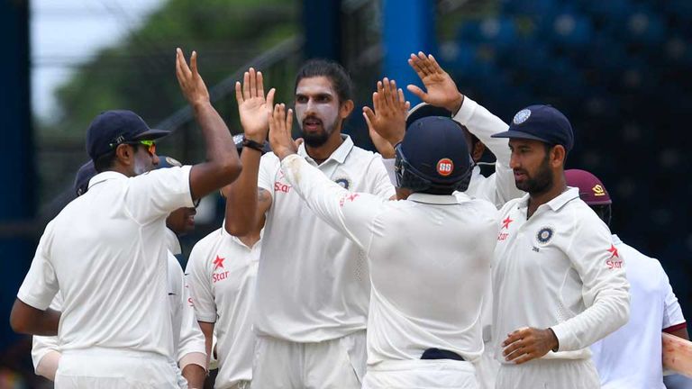 Ishant Sharma celebrates the dismissal of Leon Johnson of West Indies (partially hidden -far right) during the truncated opening day in Port of Spain.