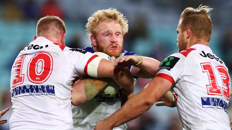 SYDNEY, AUSTRALIA - JULY 29: James Graham of the Bulldogs is tackled by Michael Cooper and Jack De Belin of the Dragons during the round 21 NRL match betwe