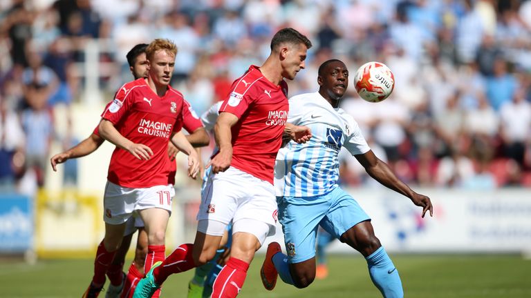 Swindon Town's Jamie Sendles-White and Coventry City's Marvin Sordell battle for the ball