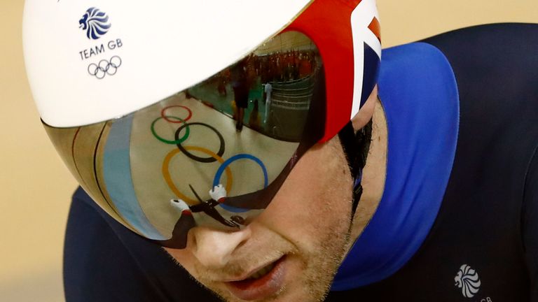 The Olympic rings are reflected on the helmet visor Jason Kenny of Britain