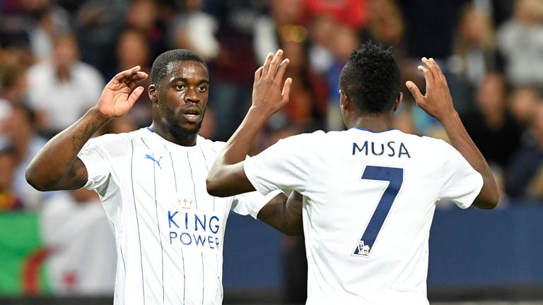 Leicester's Nigerian forward Ahmed Musa (R) celebrates with his teammate Ghanaian midfielder Jeff Schlupp after scoring a goal during the 2016 Internationa