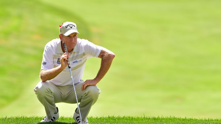 Jim Furyk of the United States lines up his putt on the 18th green during the final round of the Travelers Championship