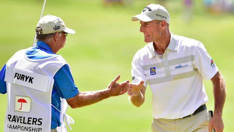 Jim Furyk celebrates with his caddie Mike "Fluff" Cowan after a shooting a record 58 at the Travelers Championship