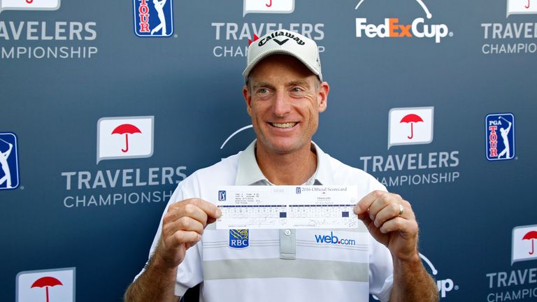Jim Furyk poses with his scorecard after shooting a record 58 during the final round of the Travelers Championship