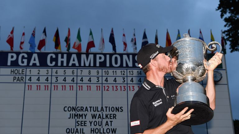 Jimmy Walker of the United States celebrates with the Wanamaker Trophy in front of the leaderboard after winning the 2016 PGA Championship
