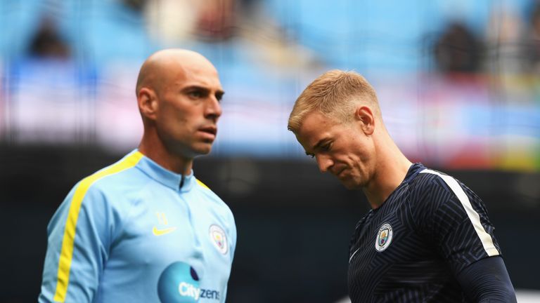 MANCHESTER, ENGLAND - AUGUST 13: Willy Cabellero of Manchester City (L) and Joe Hart of Manchester City (R) warm up prior to kick off during the Premier Le