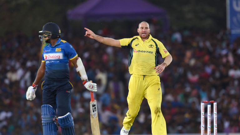 Australian cricketer John Hastings (R) celebrates the dismissal of Sri Lanka cricketer Dilruwan Perera (L) during the fourth One Day International (ODI) cr