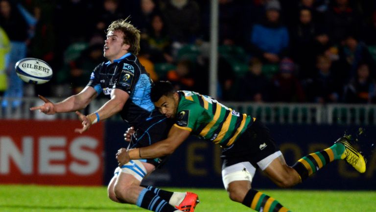 Glasgow's Jonny Gray unloads as he tackled by Northampton's Luther Burrell at Scotstoun Stadium on November 21, 2015 in G