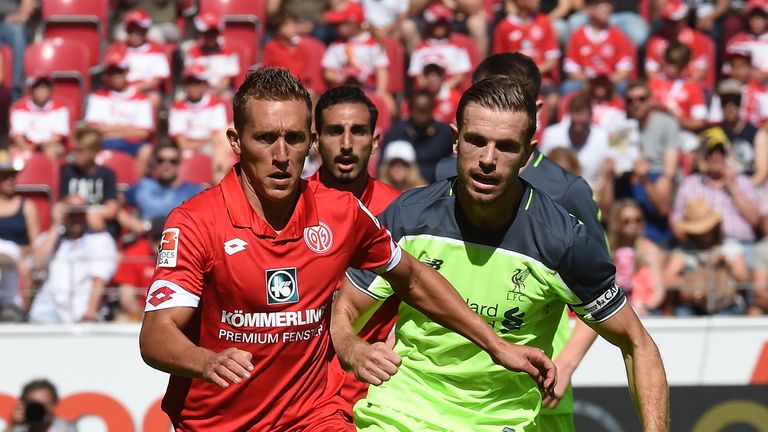 Liverpool's Jordan Henderson (R) battles for the ball during a pre-season friendly against Mainz