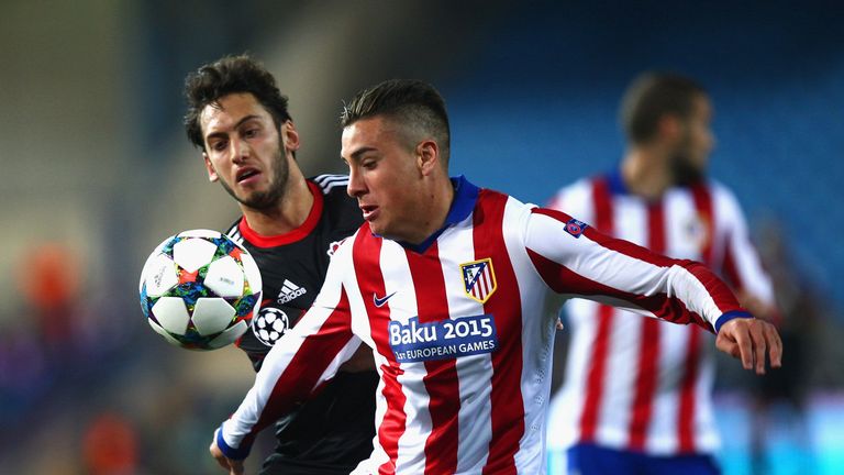 MADRID, SPAIN - MARCH 17:  Jose Gimenez of Atletico Madrid and Hakan Calhanoglu of Bayer Leverkusen compete for the ball during the UEFA Champions League r
