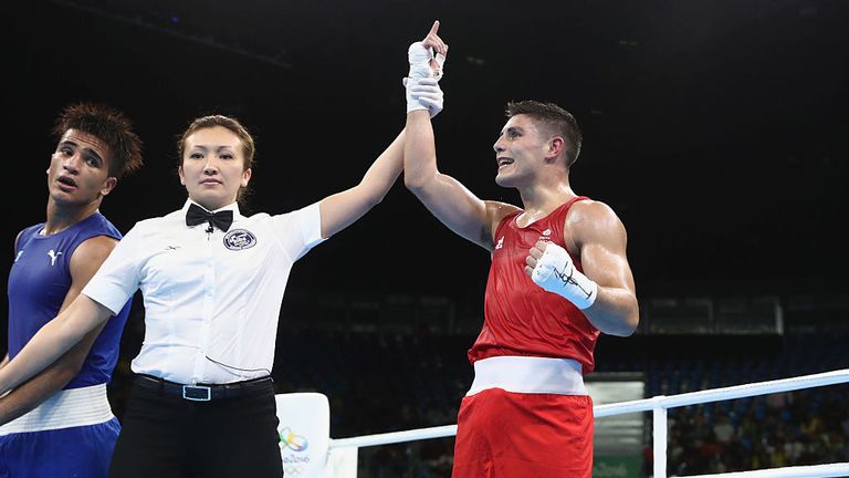 Josh Kelly of Great Britain (red) celebrates against Walid Mohamed of Egypt (blue) in their Mens 69kg Welterweight bout