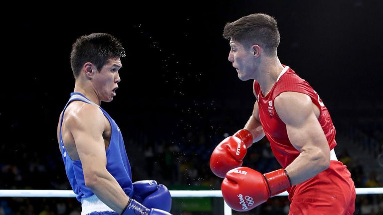 Daniyar Yeleussinov of Kazikstan (blue) fights Josh Kelly of Great Britain (red) in their Mens Welterweight bout