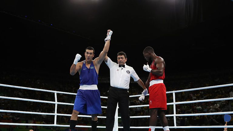 Adilbek Niyazymbetov (L) of Kazakhstan celebrates after defeating Joshua Buatsi of Great Britain