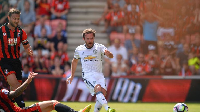Juan Mata (R) scores the opening goal for Manchester United