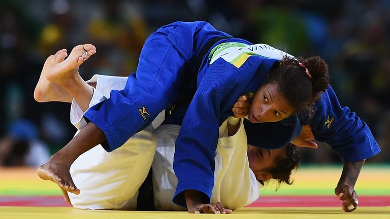 RIO DE JANEIRO, BRAZIL - AUGUST 08:  Rafaela Silva of Brazil (blue) competes against Sumiya Dorjsuren of Mongolia in the Women's -57 kg Final - Gold Medal 