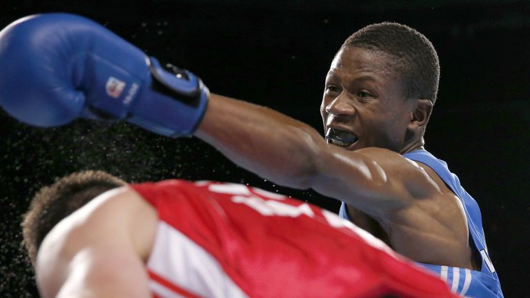 Scotland's Josh Taylor (red) fights Namibia's Junias Jonas during the men's light welter (64kg) final boxing bout at the 2014 Commonwealth Games in Glasgow