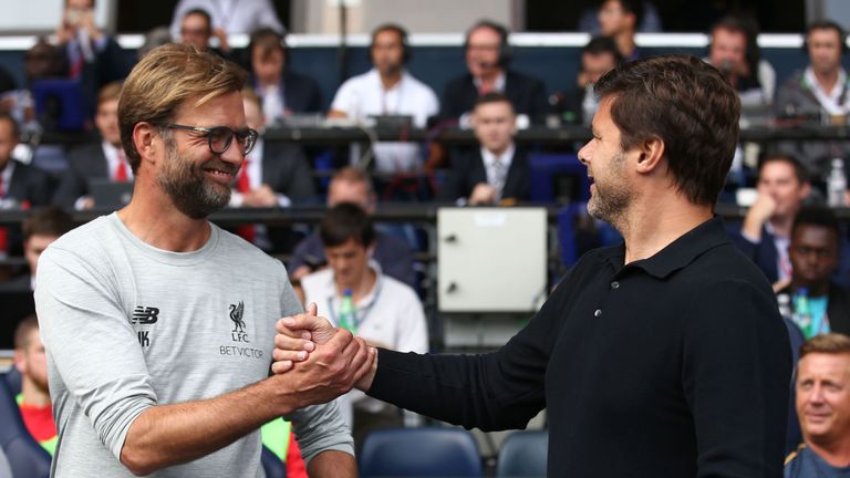 Jurgen Klopp (L) greets Mauricio Pochettino before the Tottenham v Liverpool fixture in the Premier League