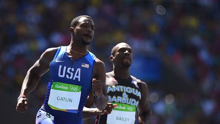 US Justin Gatlin (L) and Antigua's Daniel Bailey compete in the Men's 100m Round 1 at the Rio 2016 Olympic Games at the Olympic Stadium