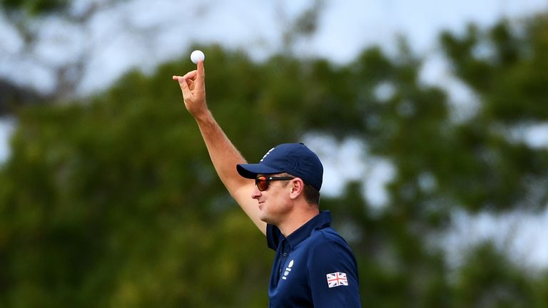 Justin Rose of Great Britain celebrates his hole in one on the fourth green during the first round of men's golf at the Rio Olympics