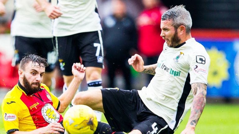 Inverness CT defender Kevin McNaughton wins a challenge against Partick Thistle's Steven Lawless