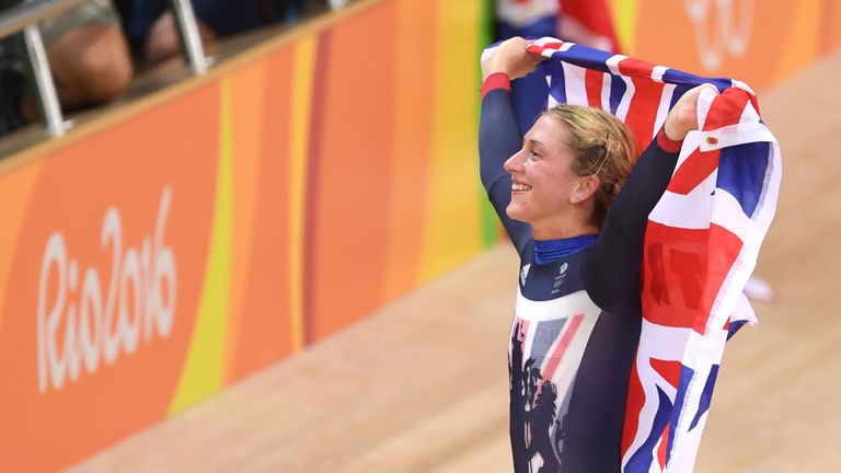 Britain's Laura Trott holds up a flag as she celebrates