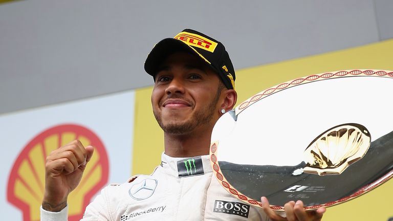 Lewis Hamilton of Great Britain and Mercedes GP celebrates on the podium after winning the Formula One Grand Prix of Belgium at Spa in 2015
