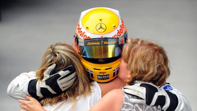 Lewis Hamilton of Britain hugs his family members after driving his McLaren Mercedes to victory in the Chinese Grand Prix at the Shanghai International Cir