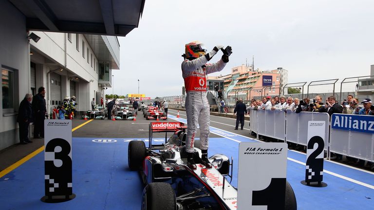 NUERBURG, GERMANY - JULY 24:  Lewis Hamilton of Great Britain and McLaren celebrates in parc ferme after winning the German Formula One Grand Prix at the N