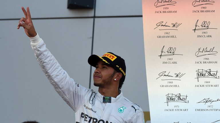 Winner Mercedes' British driver Lewis Hamilton waves from the podium after winning the inaugural Russian Formula 1 Grand Prix at the Sochi Autodrom in Soch