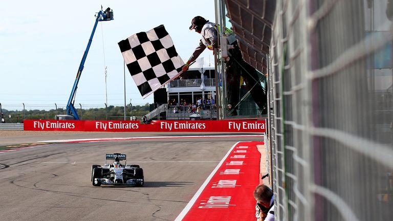 AUSTIN, TX - NOVEMBER 02:  Lewis Hamilton of Great Britain and Mercedes GP takes the checkered flag to seal victory in the United States Formula One Grand 