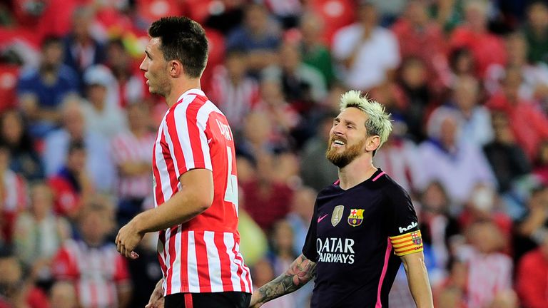 Barcelona's Argentinian forward Lionel Messi (R) grimaces during the Spanish league football match Athletic Club Bilbao vs FC Barcelona at the San Mames st