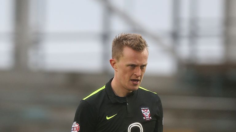 Luke Hendrie of York City walks dejectedly from the pitch after being shown a red card at Northampton