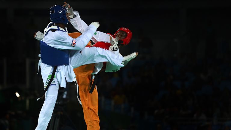 RIO DE JANEIRO, BRAZIL - AUGUST 19:  (L-R) Lutalo Muhammad of Great Britain competes against Cheick Sallah Cisse of Cote d'Ivoire in the Men's Taekwondo -8