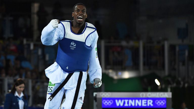 Great Britain's Lutalo Muhammad celebrates after winning against Azerbaijan's Milad Beigi Harchegani in  their men's taekwondo semi-final bout in the -80kg