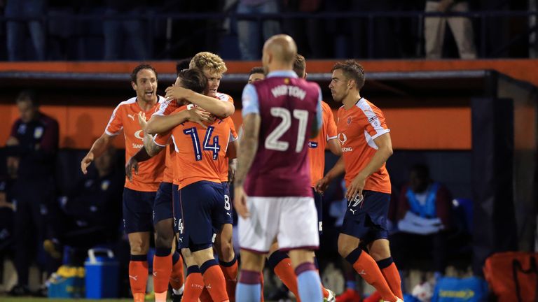 Luton Town's Cameron McGeehan (centre left) celebrates scoring his side's second goal of the game during the EFL Cup, First Round match at Kenilworth Road,