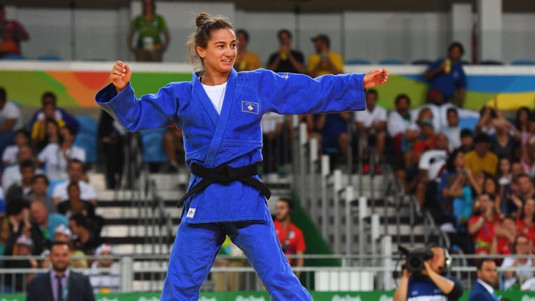 Majlinda Kelmendi of Kosovo celebrates winning the gold medal against Odette Giuffrida of Italy during the Women's Judo