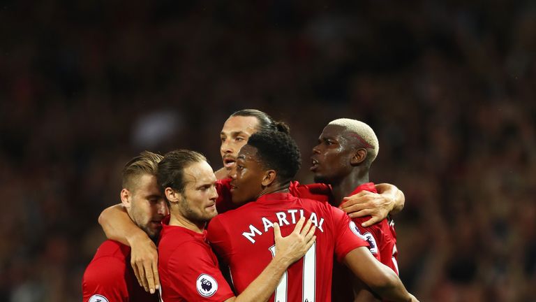 MANCHESTER, ENGLAND - AUGUST 19:  Zlatan Ibrahimovic of Manchester United celebrates scoring the opening goal with Paul Pogba (R) and team mates during the