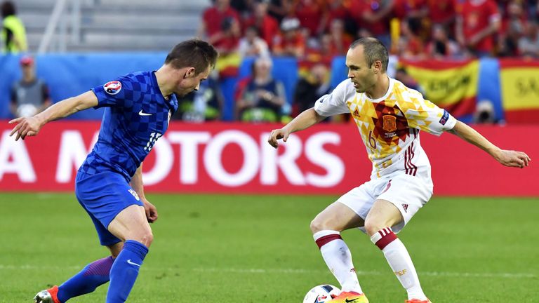 Spain's midfielder Andres Iniesta (R) controls the ball as he is marked by Croatia's midfielder Marko Rog during the Euro 2016 group D football match betwe