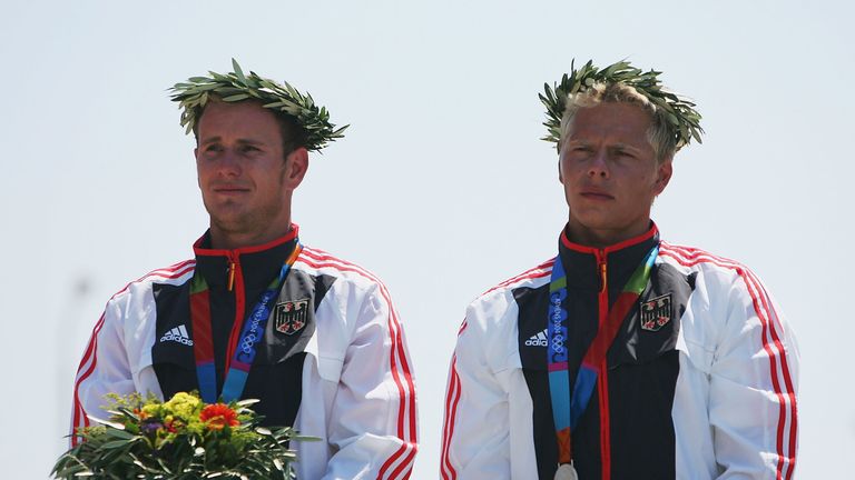 Stefan Henze (right) and Markus Becker of Germany receive their silver medals during ceremonies for the men's C-2 class slalom event at Athens Olympics