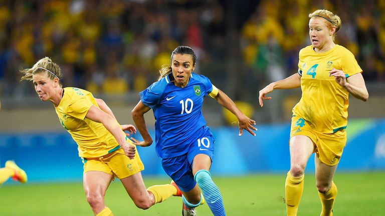 Brazil striker Marta (10) run between two Australia defenders