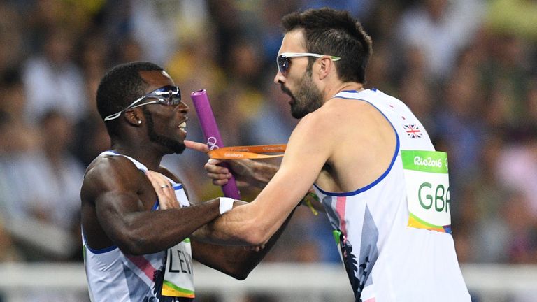 Great Britain's Nigel Levine (L) and Great Britain's Martyn Rooney celebrate their victory in the Men's 4x400m Relay Round 1 during the athletics event at 