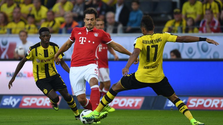 Bayern Munich's defender Mats Hummels (C) fights for the ball with Dortmund's Gabonese striker Pierre-Emerick Aubameyang during the German Super Cup footba