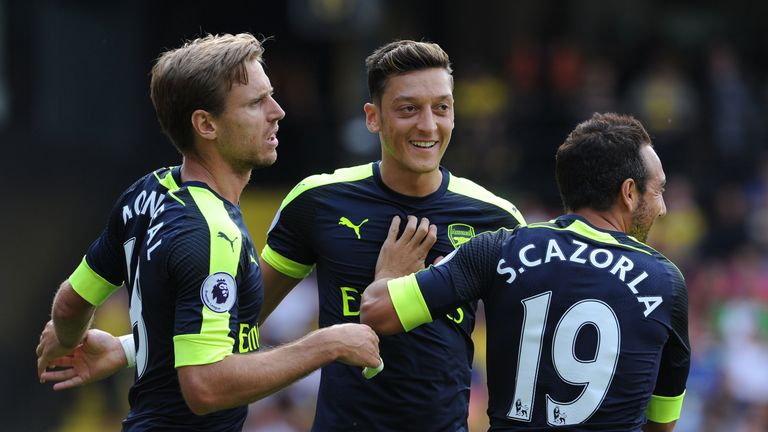 Mesut Ozil celebrates his goal in Arsenal's Premier League win at Watford with Nacho Monreal and Santi Cazorla